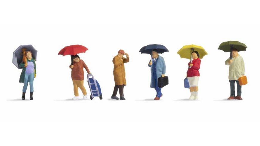 6 personnes debout sous la pluie avec parapluie