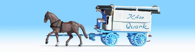 Roulotte du marchand de lait attelée d’un cheval‚ couleur blanche‚ roues bleues‚ avec cocher