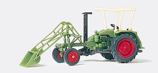 Tracteur agricole avec faucheuse latérale‚ fourche frontale‚ dispositif de chargement