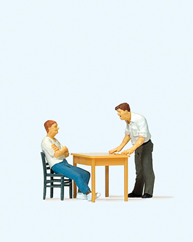 Interogatoire  un homme sur une chaise + un homme debout a une table