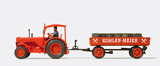 Livreur de charbon tracteur agricole et remorque charge de sacs de charbon